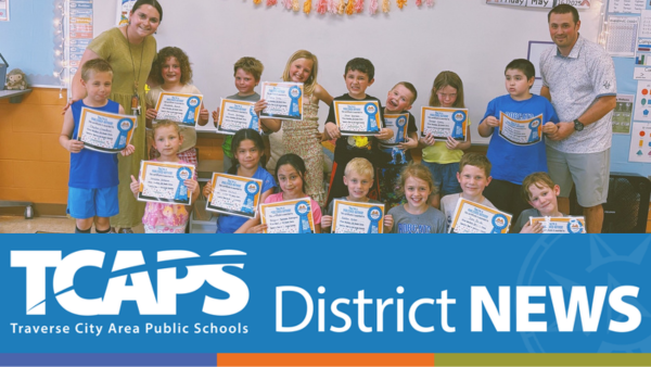 TCAPS District News with students holding certificates